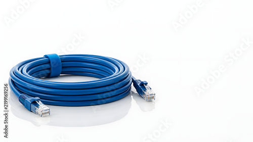 Coiled Blue Ethernet Network Cable RJ45 Connector on White Reflective Surface