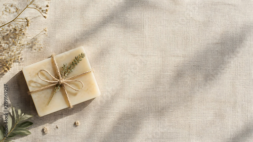 Handmade Organic Herbal Soap Bar Tied with Hemp String on Linen Background