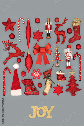 Christmas gold Joy sign with red tree bauble decorations on gray background. Festive Xmas decorative glad tidings design for holiday season.  