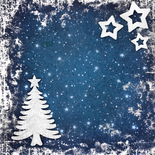 Christmas tree and star decorations grunge border background on blue. Abstract fantasy design for the holiday Xmas season.
