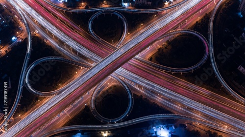 Aerial long exposure view of complex highway interchange at night