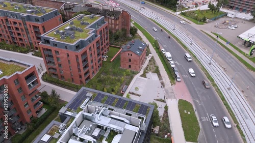 Sustainable urban development featuring solar panels, green roofs, and modern infrastructure.