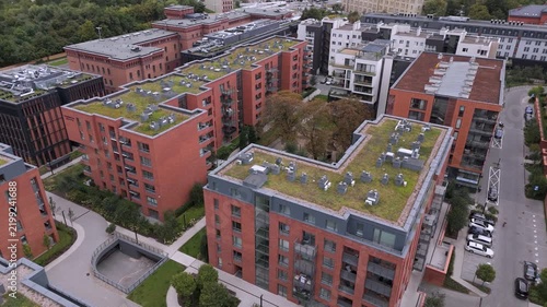 Modern sustainable architecture with green plant roofs in a residential urban neighborhood.