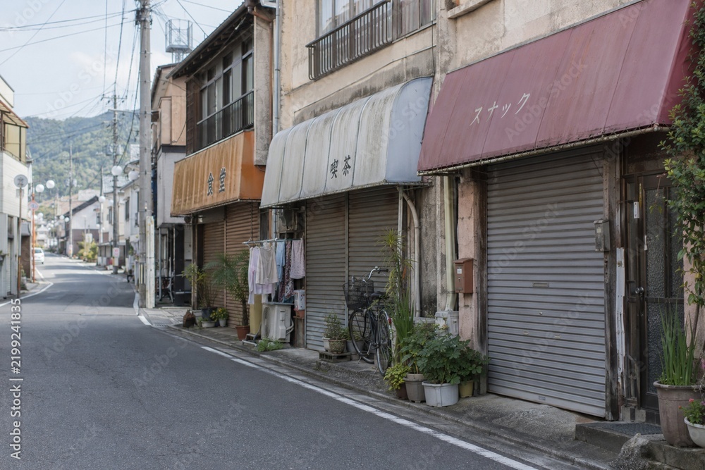 Fototapeta premium Closed Storefronts on a Quiet Japanese Neighborhood Street