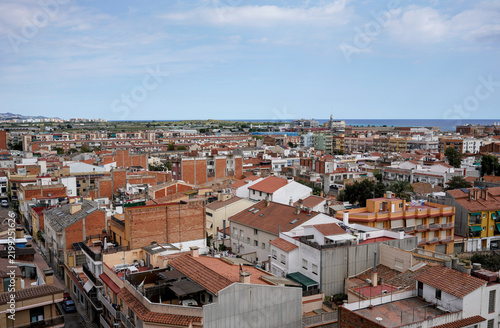 view from above on small Spanish city Malgrat de mar with narrow streets and sea in a background, daytime
