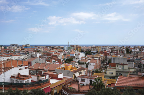 view from above on small Spanish city Malgrat de mar with narrow streets and sea in a background, daytime