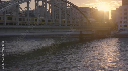 夕暮れに川を渡る電車