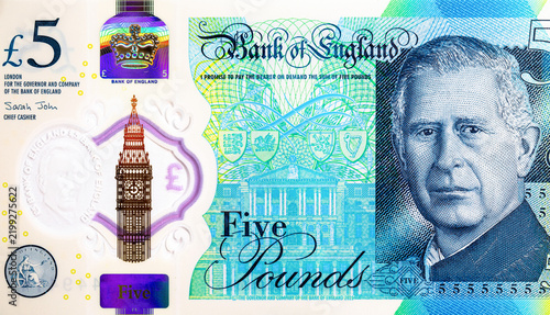 new 5 British Pound polymer banknote featuring the portrait of King Charles III. showing the Bank of England and a transparent window with Big Ben. UK national currency