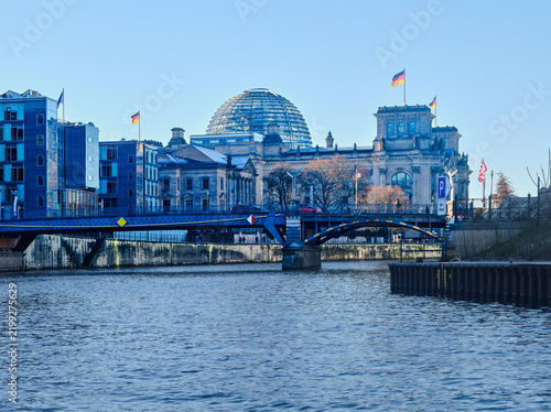 Reichstag building and glass dome above the Spree in Berlin