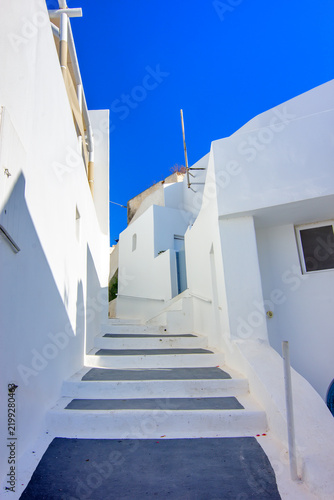 A narrow pedestrian alley in the traditional village of Megalochori on Santorini, Greece.