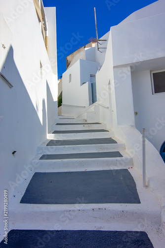 A narrow pedestrian alley in the traditional village of Megalochori on Santorini, Greece.