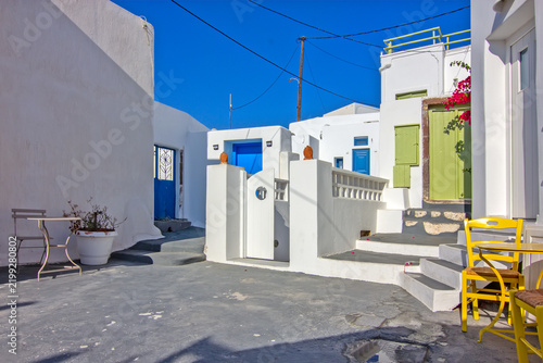 A sunlit traditional courtyard in Megalochori, Santorini.