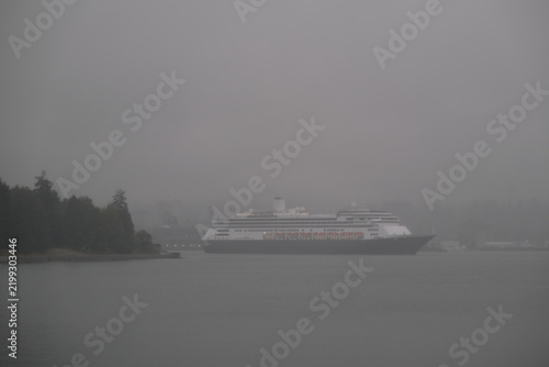 Classic luxury cruiseship cruise ship liner Zaandam Volendam arrival to Vancouver, BC after Alaska wilderness adventure Last frontier landscape nature scenery cruising with low hanging clouds misty