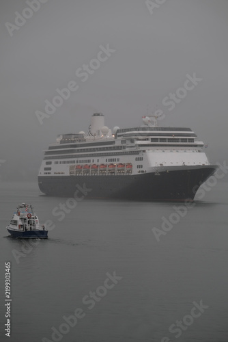 Classic luxury cruiseship cruise ship liner Zaandam Volendam arrival to Vancouver, BC after Alaska wilderness adventure Last frontier landscape nature scenery cruising with low hanging clouds misty