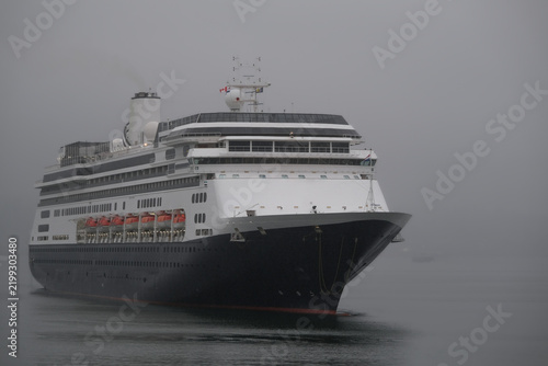 Classic luxury cruiseship cruise ship liner Zaandam Volendam arrival to Vancouver, BC after Alaska wilderness adventure Last frontier landscape nature scenery cruising with low hanging clouds misty