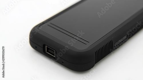 Close-up of a rugged black handheld device showing a side USB port and a sturdy protective bumper for outdoor use