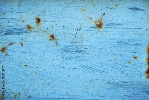 Light blue scratched metal texture with brown rust spots and peeling paint. Weathered grunge industrial background surface. Close up macro detail for retro abstract design and 3D material modeling.