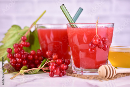 Vitamin-rich guelder rose and honey drink in glasses. Close-up.