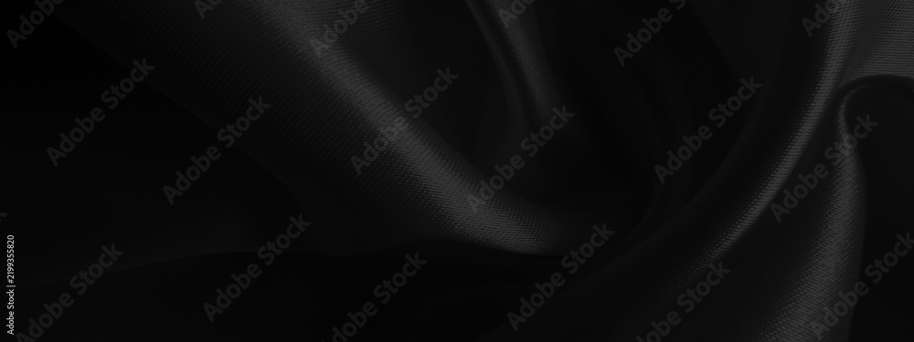 Fototapeta premium Close up of black fabric waves background texture