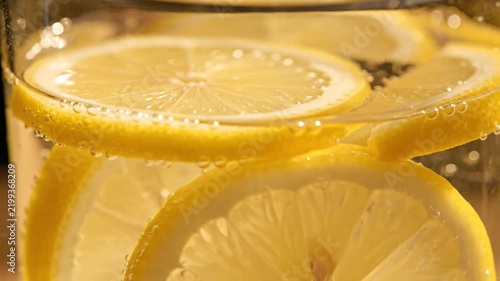 Lemon Slices Floating in Clear Water Creating Bright Refreshing Visuals