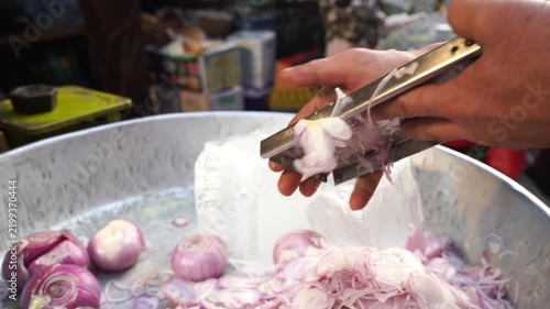 Slicing onion at the street stall, Food market of Mumbai, India