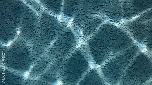 Sunlight on Water Surface: Abstract pattern of light and shadow on the surface of water, resembling dappled sunlight reflecting on a textured surface.