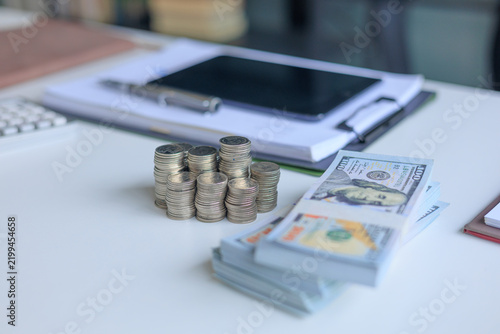 Принти на полотні Stacks of varying coin heights and bundles of neatly organized paper banknotes on office table