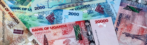 Фотография Ugandan shilling money bills in pile on table