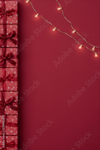Decorative Gifts and String Lights on a Red Background for Celebration