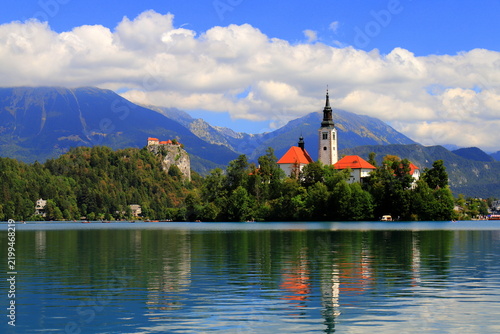 Lake Bled, Slovenia: Scenic view of the Assumption of Mary Church on the island with Bled Castle on a cliff and mountains