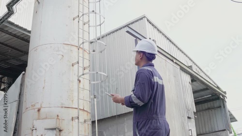 Environmental engineer conversation with team of technicians use radio, tablet and taking report to continuous emission monitoring systems at industrial plant. Sustainable air pollution reduction. ESG