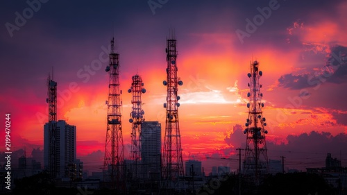 Sunset skyline with silhouetted communication towers. Artificial intelligence image