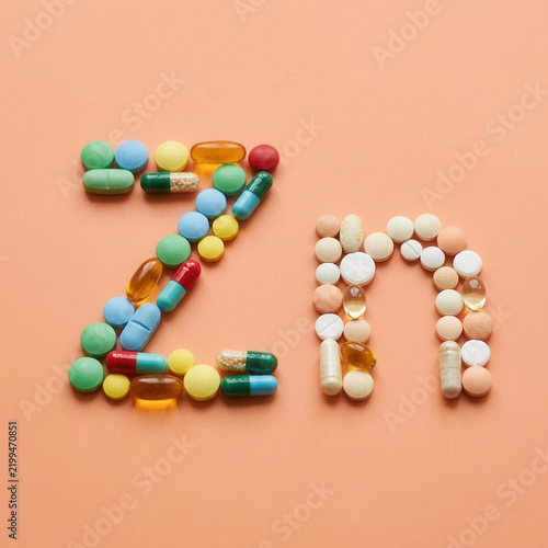 Zinc Element Symbol Formed By Colorful Medical Capsules And Tablets Isolated On Peach Background