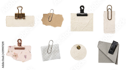 Collection of blank vintage paper scraps memo notes and tags with metal clips and pins isolated on white background