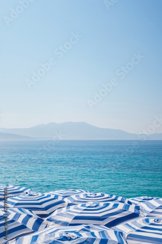 Beach Umbrellas on a Sunny Day by the Ocean With Distant Mountains