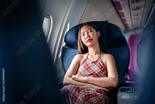 traveler woman peacefully sleeps rests on comfortable airplane s