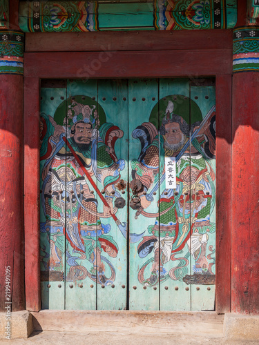 View of the traditional painted wooden doors featuring guardian deities at Gyeongbokgung Palace in Seoul, Seoul, South Korea.