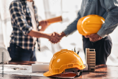 Two construction professionals shaking hands after project planning meeting