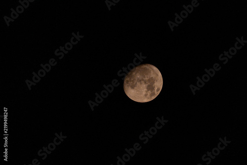 View of the moon shining brightly in the dark night sky over Pakistan.