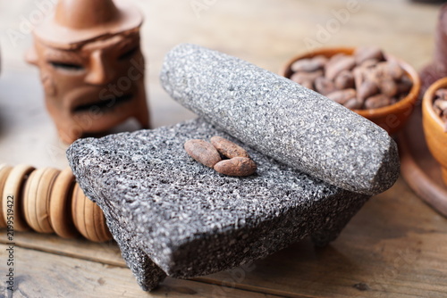 Cacao beans on a traditional stone grinder