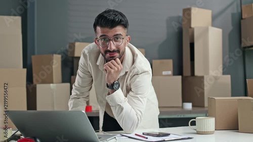 Man sits at desk, thinking deeply