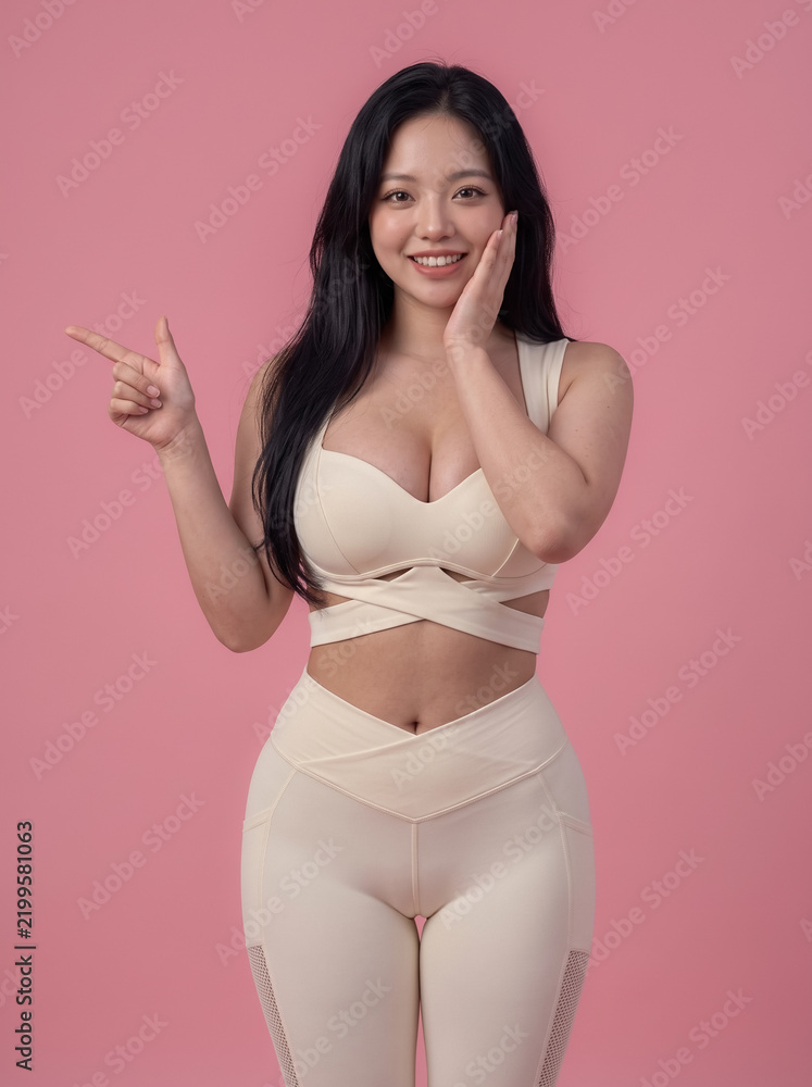 Fototapeta premium Smiling fitness woman posing in beige sportswear