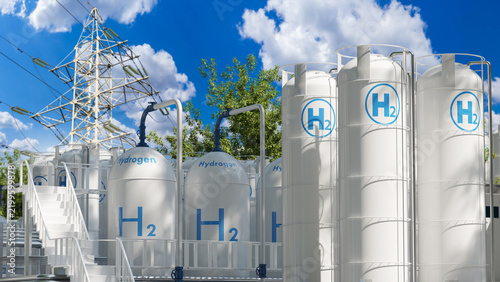Hydrogen production. Industrial hydrogen storage tanks stand beside high voltage power lines, supporting clean energy generation, grid integration and sustainable fuel supply.