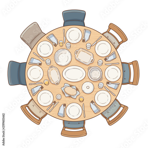 Top view of a round dining table set for a meal with chairs