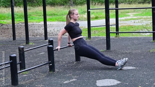 Active girl training triceps on a sports ground outdoors, bodyweight exercise, toned arms, energy and strength concept. 4K footage. Vertical video