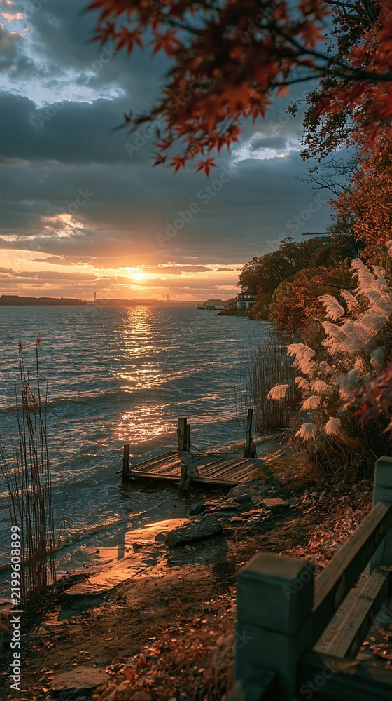 Fototapeta premium Serene Lakeside Sunset with Autumn Foliage and Old Wooden Dock