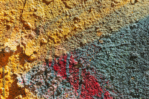 Urban palimpsest and intuitive harmony of chaos on rough wall abstract art texture with unconventional ochre blue and crimson combination industrial background