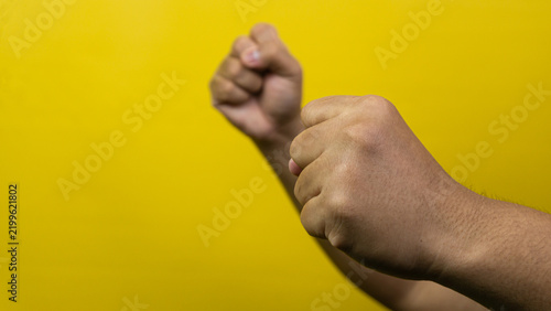 Bild auf Leinwand Two male hands are raised with clenched fists in a defensive boxing guard or fig