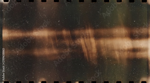 Abstract vintage film texture featuring cinematic light leaks and 35mm film strip edges with sprocket holes, heavy dust and scratches, distressed analog photography background for retro overlay