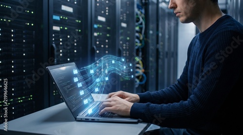 Man using laptop with data stream projection in server room